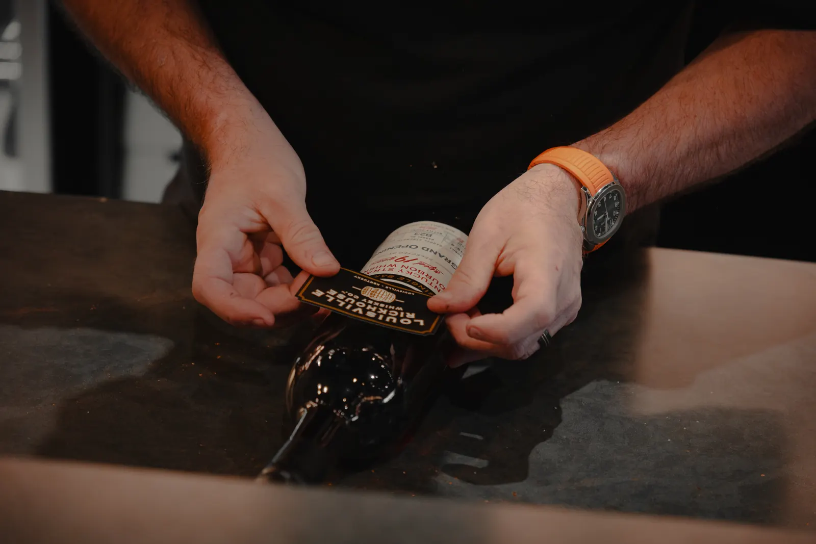 Hand-labeling a Grand Opening 19-year single barrel bourbon bottle at Louisville Rickhouse
