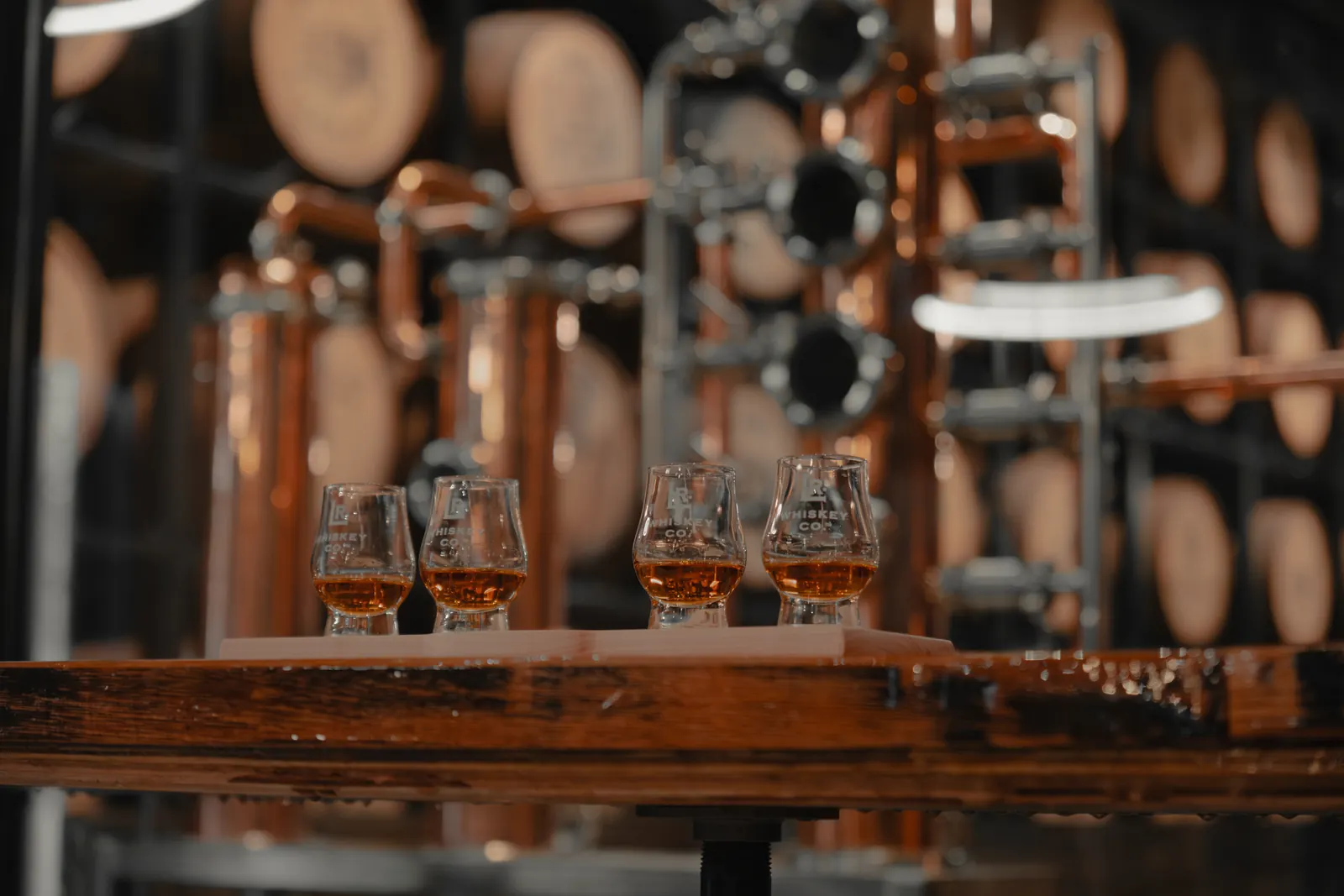 Whiskey flight in LR glasses in front of the copper still at Louisville Rickhouse