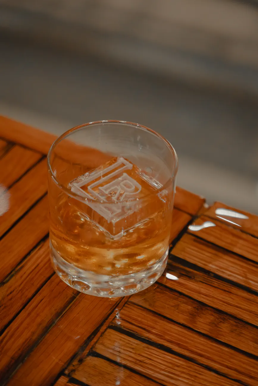 Barrel-aged Old Fashioned with an LR-stamped ice cube on the bar at Louisville Rickhouse