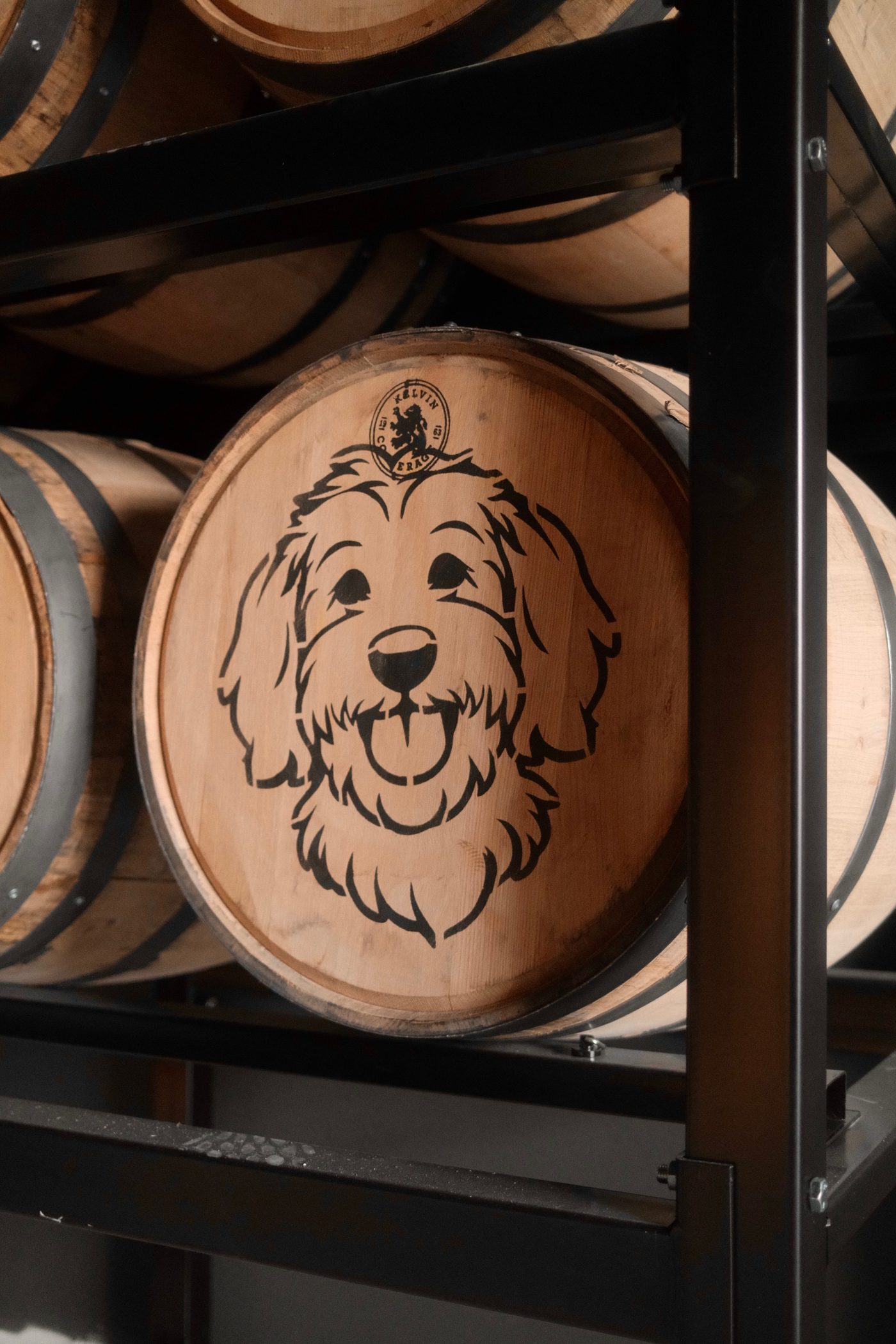 Stella the Goldendoodle barrel head on a Louisville Rickhouse single barrel